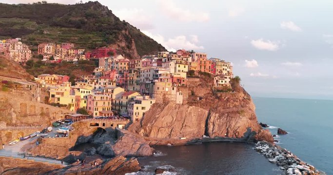Amazing aerial view of Manarola village on cliff rocks and turquoise sea.Stunning view of beautiful and cozy town in Cinque Terre Reserve,Liguria,Italy,Europe.Travel destination, adventure concept.
