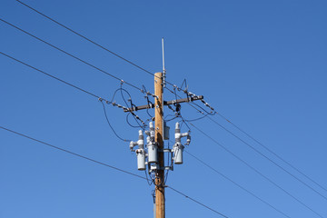 Electric power lines with power circuit breakers and antenna on new wooden pole