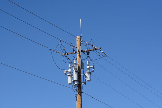Electric power lines with power circuit breakers and antenna on new wooden pole