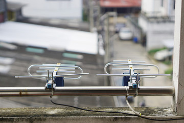 Two Small television aerial antenna in front of home.