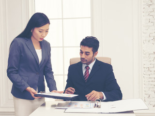 Elegant secretary bringing some documents for signature to her boss. Management review document for meeting. Document for manager approval.