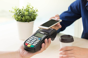 Customer paying their order making a contactless smartphone payment.