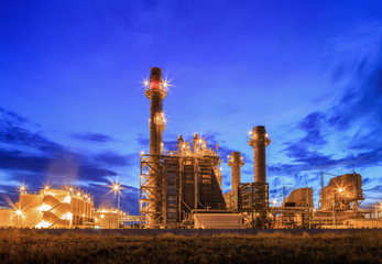 Gas turbine electrical power plant at dusk with blue sky
