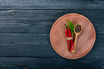 Hot spices Chili and Spice Red Peppers. On a wooden background. Top view. Free space for your text.