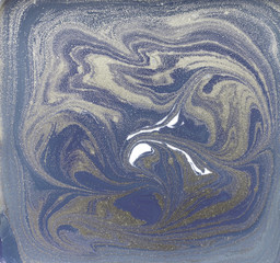 Liquid gold marbled pattern. Pale blue background.