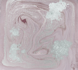 Liquid gold marbled pattern. Pale pink background