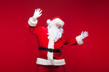 Santa Claus is dancing Isolated on red background.