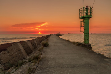 The tower on the bench in sunset
