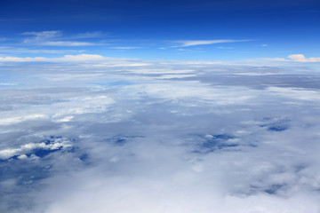 Fototapeta na wymiar Puffy clouds seen from an airplane.