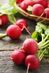 Red radishes on grey wooden table
