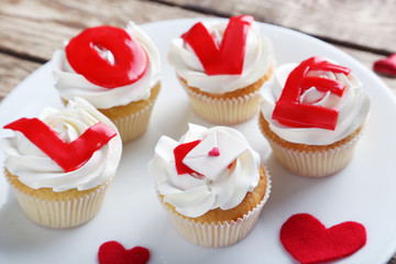 Tasty cupcakes on a brown wooden table
