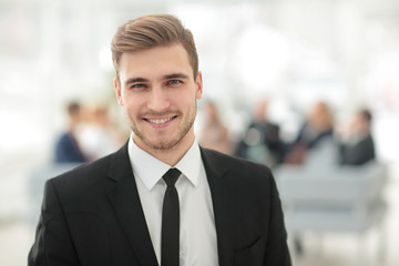 portrait of confident young businessman on blurred background.