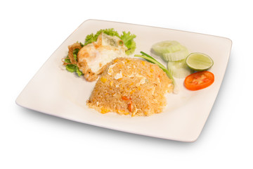 Homemade Thai fried rice with vegetables and crab meat, chicken and fried eggs served on a traditional plate object isolate on white background with clipping path.