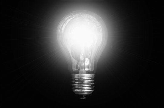Glowing light bulb isolated on black