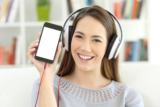 Girl listening to music showing   blank smart phone screen