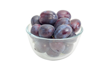 Plums in a glass bowl on a white background