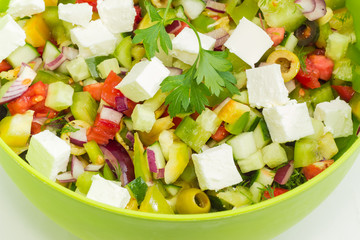 Greek salad in green bowl closeup