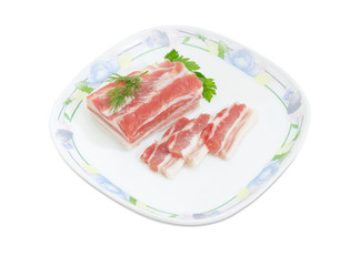 Partly sliced uncooked pork belly on dish