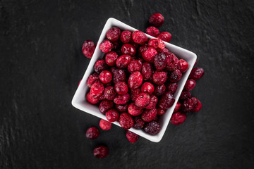 Slate slab with Dried Cranberries (selective focus; close-up shot)