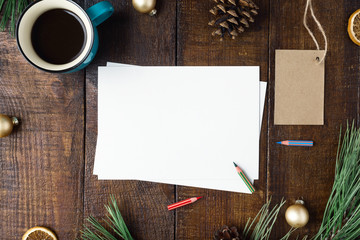 Christmas card with decorations and cup coffee on wooden table