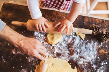 Young family making cookies at home.