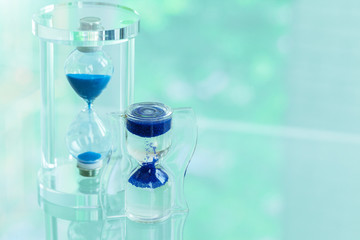 Time passing. Blue hourglass.