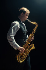 Obraz na płótnie Canvas Young man playing the Saxophone