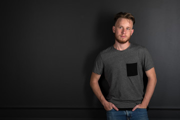 portrait of young man above black background