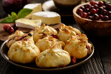Puff pastry pies with camembert cheese and cranberries. 