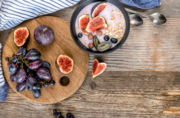 An useful dessert - yogurt, muesli and figs with grapes top view