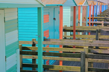 A row of colorful wooden Huts along the seafront in Whitstable, UK
