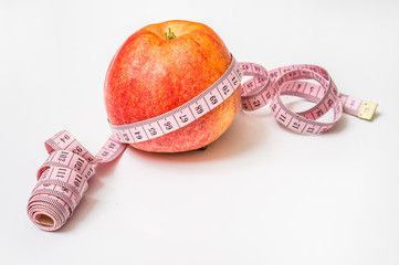 Red apple with measuring tape - diet concept
