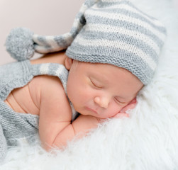 Adorable newborn boy sweetly sleeping, close-up.