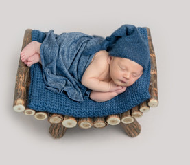 Cute boy in blue bonnet sleeping