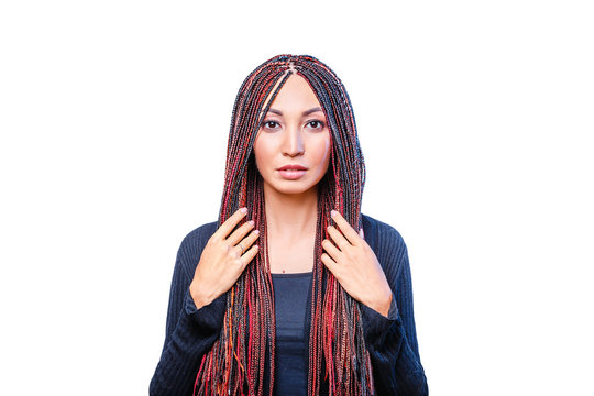 Isolated on white woman with colorful hair braided in thin plaits or dreadlocks in african style