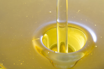 Pouring olive oil with bubbles.