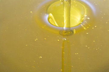 Closeup of olive oil waterfall.