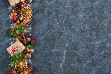 Happy New Year and Merry Christmas! New-year background with decorations of cones, nuts and cinnamon.