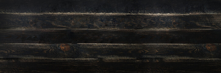 Black painted wood texture background, copy space, top view. Banner
