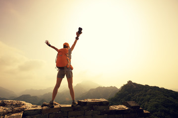 successful woman tourist on top of mountain enjoy the view