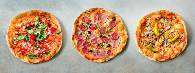 Pizza pattern. Three pieces set on grey concrete background. Top view, copyspace - obrazy, fototapety, plakaty