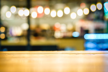 Selective  focus of wooden table in front of decorative indoor string lights. Christmas, festival...