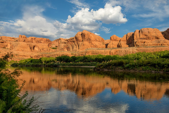 Colorado River in the evening with mountains in the background that are reflected in the water. Along UT-279 / Potash Road, Utah, USA