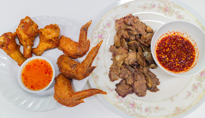 Fried chicken wings and legs with grilled pork and Thai spicy sauce, Thai Northeast food