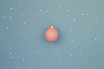 Pink Christmas ball on blue background