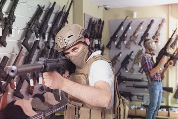 men in army uniform with gun in military market