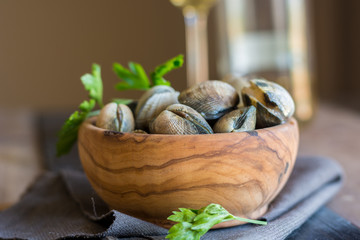 Wooden Bowl full of clams live, ready to be cooked.