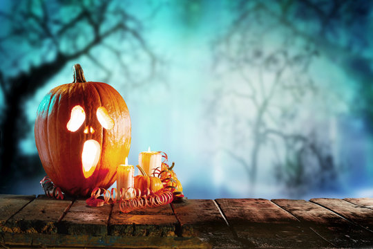 Pumpkin with candles on halloween background