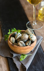 Wooden Bowl full of clams live, ready to be cooked.
