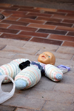 Abandoned toy doll on a street in Madrid Spain